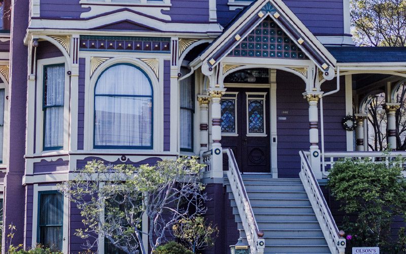 The front steps and door of a blue house